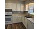 White kitchen cabinets, new countertops, and stainless steel appliances at 213 Lone Pine Dr, Edgewater, FL 32132