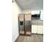 Kitchenette features stainless steel refrigerator, microwave, and white cabinets at 236 Plaza Oval, Casselberry, FL 32707