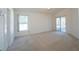Spacious bedroom with neutral carpet, sliding glass doors, and a ceiling fan at 2370 Alton Rd, Deltona, FL 32738