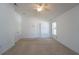 Bright bedroom with neutral carpet, double doors, and a ceiling fan at 2370 Alton Rd, Deltona, FL 32738