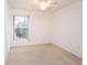 Bright bedroom with neutral walls, carpet, ceiling fan, and window with view at 2370 Alton Rd, Deltona, FL 32738
