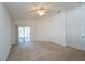 Bright bedroom with carpet flooring, ceiling fan, and sliding glass doors leading to a patio at 2370 Alton Rd, Deltona, FL 32738