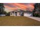 Single-story house with a landscaped lawn, driveway, and attached garage at 2370 Alton Rd, Deltona, FL 32738