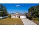 Single-story house with a landscaped lawn, driveway, and attached garage at 2370 Alton Rd, Deltona, FL 32738