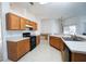 Kitchen with light wood cabinets, black appliances, and an island at 2370 Alton Rd, Deltona, FL 32738