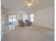 Open living room with two recliners and access to the patio at 2370 Alton Rd, Deltona, FL 32738