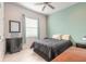 Bedroom with a king-size bed and teal accent wall at 238 Venetian Palms Blvd, New Smyrna Beach, FL 32168