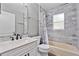 Bathroom features a modern vanity, tub and shower combination, and modern tile at 2424 India Blvd, Deltona, FL 32738