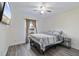 Bright bedroom features ceiling fan, modern flooring, and view of the lake at 2424 India Blvd, Deltona, FL 32738