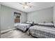 Bedroom includes two beds, a ceiling fan, and a large window for natural light at 2424 India Blvd, Deltona, FL 32738