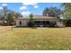 Charming brick home featuring a well-manicured lawn and a screened-in patio for outdoor living at 2424 India Blvd, Deltona, FL 32738