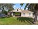Charming single-story brick home with a well-manicured lawn and mature landscaping at 2424 India Blvd, Deltona, FL 32738
