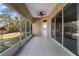 Covered lanai offers ample space for outdoor dining with tiled flooring and lush views at 2424 India Blvd, Deltona, FL 32738