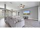 Bright living room with gray walls, wood flooring, and a large comfortable sectional at 2424 India Blvd, Deltona, FL 32738