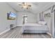 Large main bedroom boasts vaulted ceilings, ceiling fan, neutral walls and modern flooring at 2424 India Blvd, Deltona, FL 32738