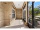 Covered porch with tile flooring and brick pillars, offering a relaxing outdoor space at 2424 India Blvd, Deltona, FL 32738