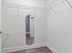 Walk-in closet offers ample storage space with built in wire shelving and neutral walls at 2424 India Blvd, Deltona, FL 32738