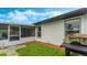 Spacious backyard with grill, landscaping, and screened patio at 2625 Sweet Springs St, Deltona, FL 32738