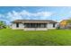 Large backyard with screened patio and grassy area at 2625 Sweet Springs St, Deltona, FL 32738