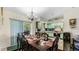 Dining room with dark wood table and chairs, adjacent to kitchen at 2625 Sweet Springs St, Deltona, FL 32738