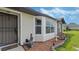 House exterior detail; vinyl siding, brick accents, and a walkway at 2625 Sweet Springs St, Deltona, FL 32738