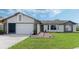 Brick and siding house with a 2-car garage and landscaped lawn at 2625 Sweet Springs St, Deltona, FL 32738