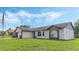 House exterior showcasing brick and vinyl siding with a well-maintained lawn and American flag at 2625 Sweet Springs St, Deltona, FL 32738