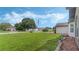 Landscaped front yard with a large tree and a view of the neighborhood at 2625 Sweet Springs St, Deltona, FL 32738