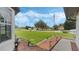 Landscaped front yard with a view of a residential street and American flag at 2625 Sweet Springs St, Deltona, FL 32738