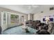 Living room with sectional sofa, large TV, and a ceiling fan at 2625 Sweet Springs St, Deltona, FL 32738
