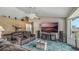 Living room with sectional sofa, large TV, and a ceiling fan at 2625 Sweet Springs St, Deltona, FL 32738