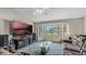 Living room with sectional sofa, large TV, and bay window view at 2625 Sweet Springs St, Deltona, FL 32738