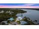 Expansive waterfront property at sunset, showcasing the home and surrounding area at 2806 Bay Vista Ct, New Smyrna Beach, FL 32168