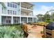 Large backyard deck with fire pit and grill at 2806 Bay Vista Ct, New Smyrna Beach, FL 32168