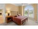 Bedroom with a bed, nightstand, and large window with blinds at 2806 Bay Vista Ct, New Smyrna Beach, FL 32168