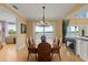Bright dining room with water views and a large chandelier at 2806 Bay Vista Ct, New Smyrna Beach, FL 32168