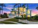 Beautiful waterfront home with palm trees and a white picket fence at 2806 Bay Vista Ct, New Smyrna Beach, FL 32168