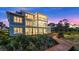 Back view of home showcasing large screened porch and boardwalk access at 2806 Bay Vista Ct, New Smyrna Beach, FL 32168