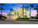 Two-story waterfront home with large windows and a three-car garage at 2806 Bay Vista Ct, New Smyrna Beach, FL 32168