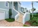 Side view of home showcasing stairway and landscaping at 2806 Bay Vista Ct, New Smyrna Beach, FL 32168