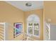 Stairwell with a large arched window and modern light fixture at 2806 Bay Vista Ct, New Smyrna Beach, FL 32168