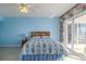 Blue bedroom with ocean view and ceiling fan at 2967 S Atlantic Ave # 1706, Daytona Beach, FL 32118