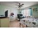 Bright bedroom with ceiling fan, tile flooring, and ample storage at 30215 Tavares Ridge Blvd # 11, Tavares, FL 32778