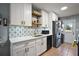 Clean kitchen with stainless steel appliances, white cabinets, and an adjacent laundry area at 30215 Tavares Ridge Blvd # 11, Tavares, FL 32778