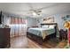 Spacious main bedroom with dark wood furniture, ceiling fan, and natural light at 30215 Tavares Ridge Blvd # 11, Tavares, FL 32778