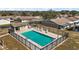 Community pool with chairs, bathrooms, and black metal fence at 30215 Tavares Ridge Blvd # 11, Tavares, FL 32778