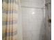 Shower with modern tile, shower head, and decorative curtain at 30215 Tavares Ridge Blvd # 11, Tavares, FL 32778