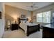 Bright bedroom with double bed, window, and dark wood furniture at 3162 Kailani Ct, Ormond Beach, FL 32174