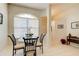 Small breakfast nook with glass table and chairs near the kitchen at 3162 Kailani Ct, Ormond Beach, FL 32174