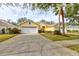 Two-story yellow house with a two-car garage and landscaped yard at 3162 Kailani Ct, Ormond Beach, FL 32174